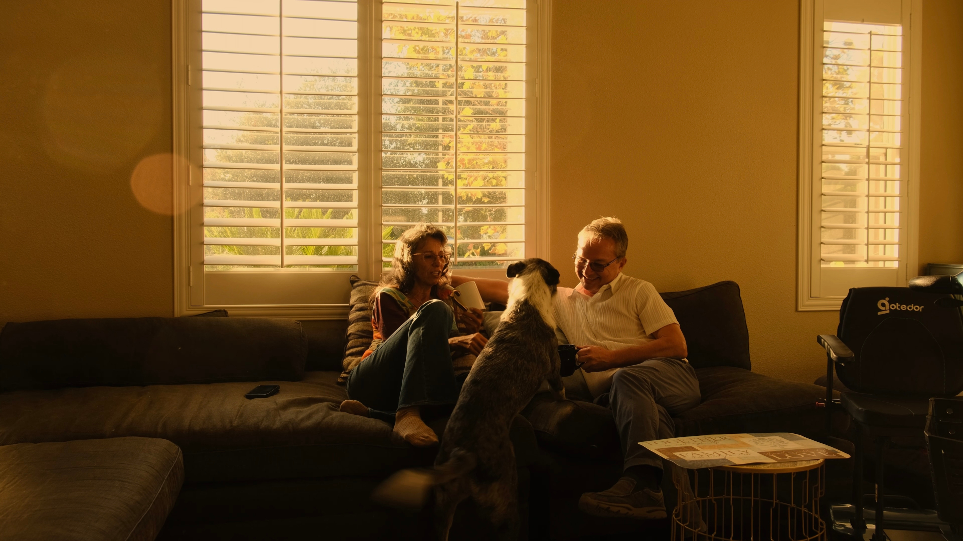Couple and dog in golden window light