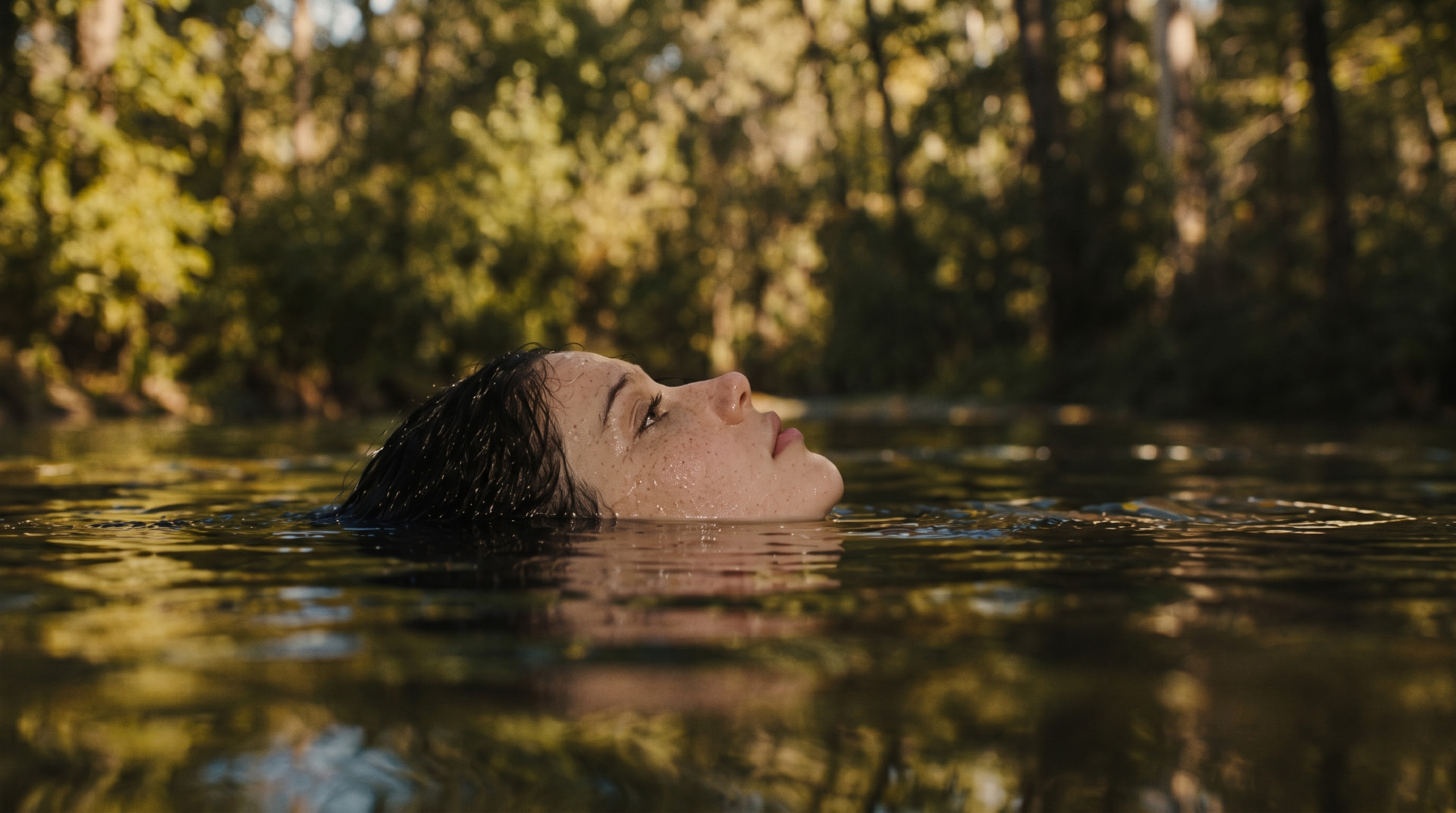 Woman floating in a sunlit river