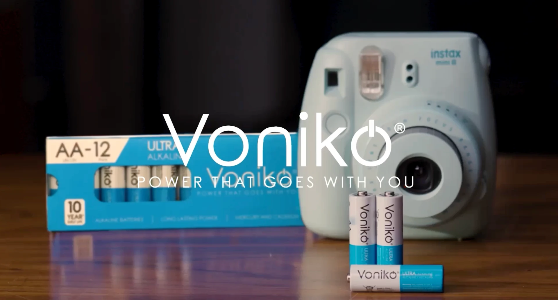 Voniko batteries beside an instant camera