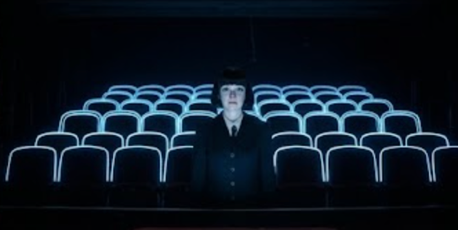 Lone figure in empty theater